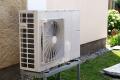 Heat pump unit installed outdoors, showcasing eco-friendly HVAC technology for efficient heating and cooling solutions.