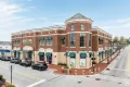 Barnes & Noble Booksellers storefront on Main Street at Exton, featuring a brick facade, green awnings, and surrounding parked cars, highlighting the vibrant shopping atmosphere in Exton, PA.