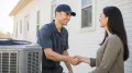 HVAC technician shaking hands with a homeowner beside an air conditioning unit, symbolizing reliable AC replacement services in West Chester, PA.