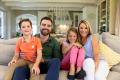Family enjoying time together in a cozy living room, highlighting comfort and warmth, relevant to Precision Air's HVAC services for maintaining home comfort in Malvern, PA.