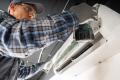 HVAC technician performing maintenance on a split air conditioning unit, emphasizing expertise in air conditioning services for residential comfort in Willistown Township.