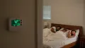 Family sleeping peacefully in a bedroom with a thermostat displaying 72°F, emphasizing comfort and effective HVAC service in Glen Mills.