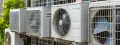 Multiple outdoor HVAC units installed on a wall, showcasing energy-efficient cooling systems relevant to Southeastern Pennsylvania's climate control needs.