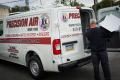 Precision Air van for HVAC services, including heating and cooling, in West Chester, PA. Technician loading equipment for repairs.