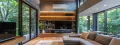 Modern living room with HVAC system, large windows overlooking greenery, comfortable sofa, and entertainment center, emphasizing energy efficiency and comfort in residential spaces.