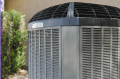 Air conditioning unit in a residential setting, highlighting the exterior design and structure relevant to HVAC system options.