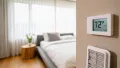 Thermostat displaying 72°F in a cozy bedroom with soft lighting and a neatly made bed, emphasizing the importance of HVAC maintenance for consistent heating during winter in Glen Mills, PA.