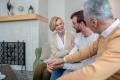 Family discussing home comfort and HVAC solutions in a cozy living room setting, emphasizing the importance of regular maintenance for heating and cooling systems.