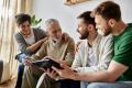 Family gathered around a photo album, sharing joyful moments, emphasizing connection and memories in a cozy living room setting.