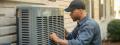 HVAC technician servicing an air conditioning unit in West Chester, PA. AC repair and maintenance for home cooling systems. Expert HVAC services.