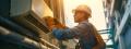 HVAC technician installing an air conditioning unit outdoors, emphasizing professional AC installation services in Phoenixville, PA.
