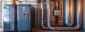 Furnace and HVAC system with visible ductwork and control panel, showcasing essential components for winter heating maintenance in West Chester.