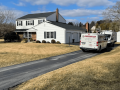 HVAC company trucks at a home in West Chester, PA. Choosing the right HVAC company for your home's heating and cooling needs.