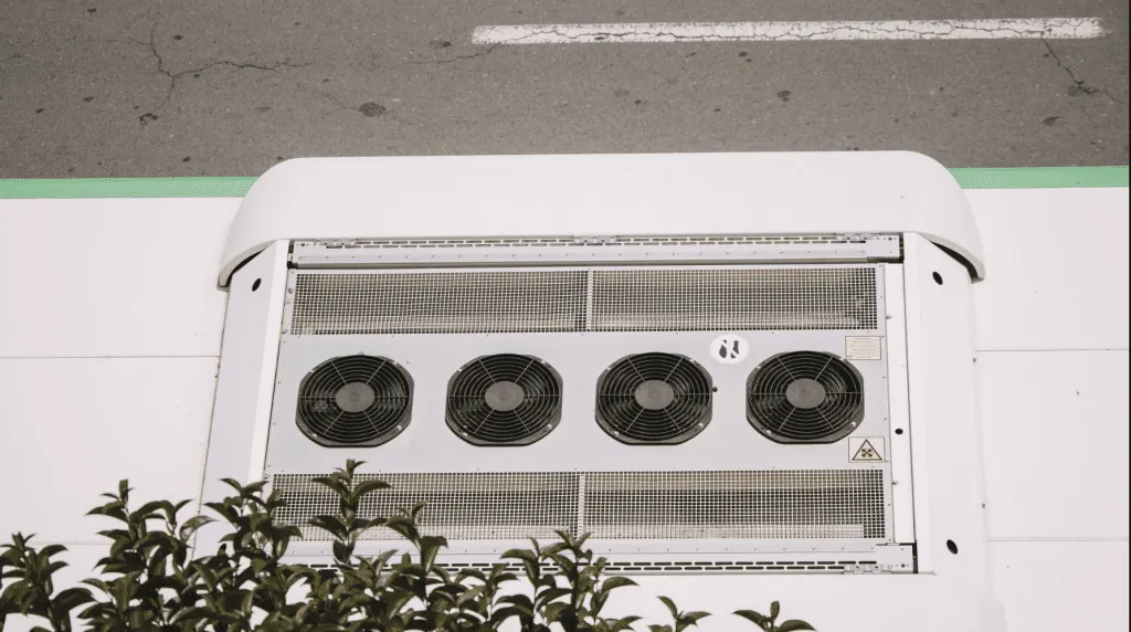 Large AC unit with four fans, part of AC Replacement Services in Phoenixville PA, cooling system.
