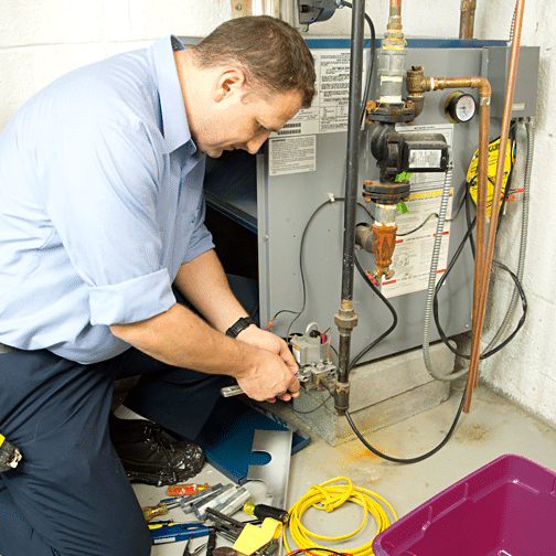 Furnace installation showing technician repairing a home heating system. Call for furnace replacement or new install in West Chester, PA.