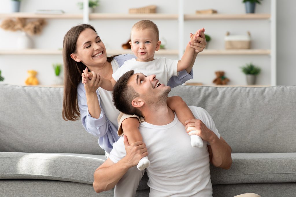 Happy family enjoying time together in their home; focus on comfort. Consider a new furnace installation for a cozy home in West Chester, PA.