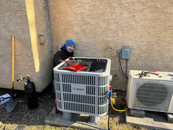 Bosch heat pump installed outside a stucco home | Precision Air