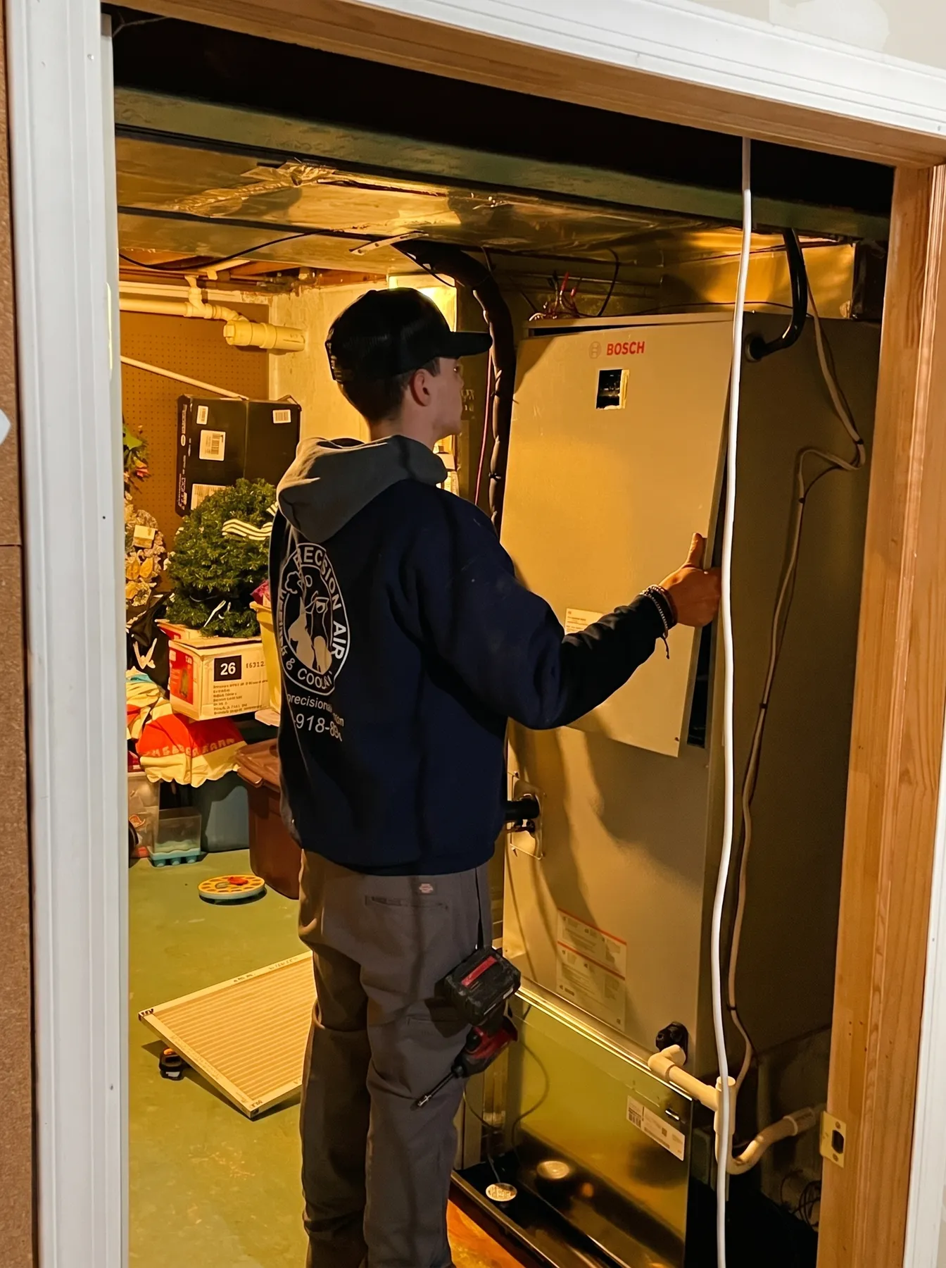 Precision Air technician installing a Bosch furnace