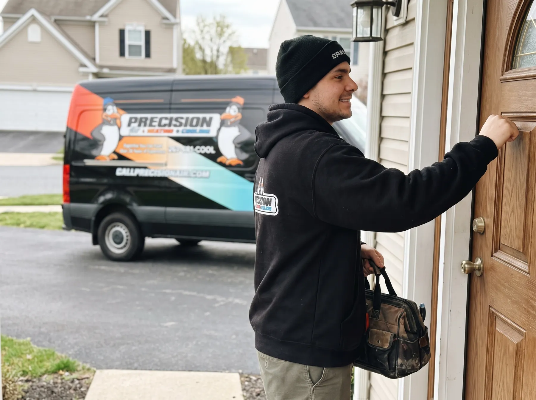 Precision Air technician at a customer's front door